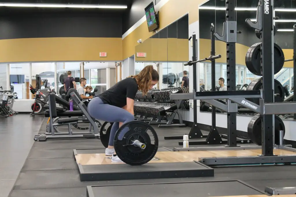 Woman sumo deadlifting