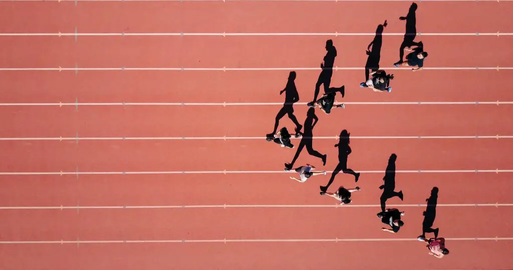track and field athletes with shadows