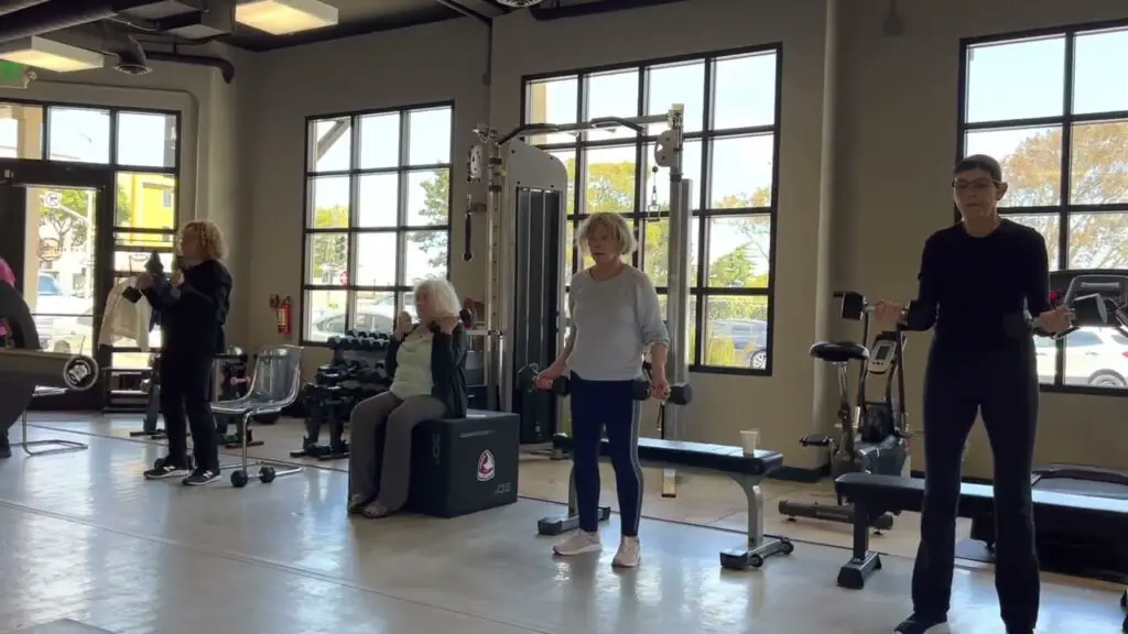 senior women lifting weight upper body