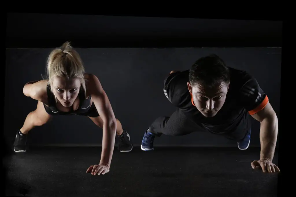 one arm push up man and woman