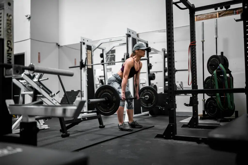 woman with hat deadlifting
